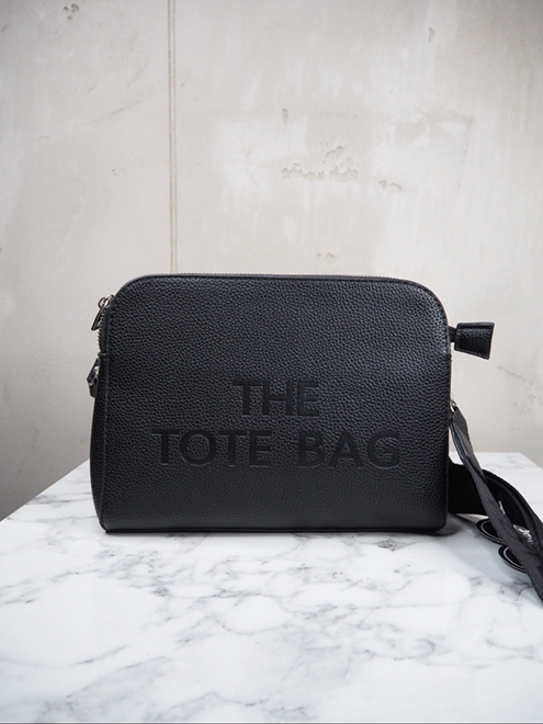italienische mode kleiber werksverkauf Schwarze Einkaufstasche aus Leder mit der Prägung „The Tote Bag“.